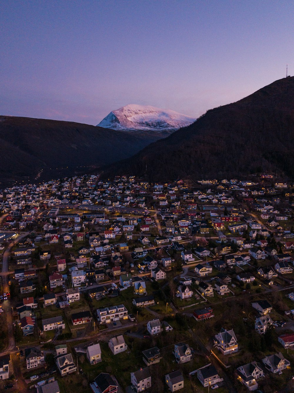 an aerial view of a city with a mountain in the background