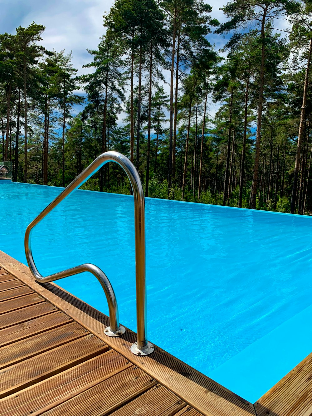 a large swimming pool with a wooden deck