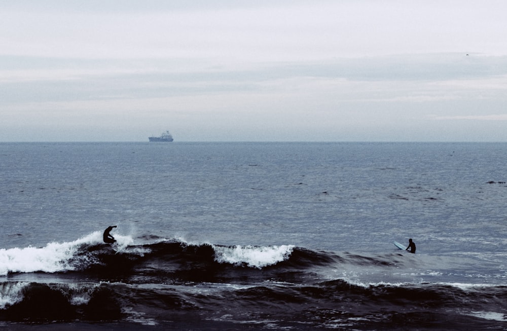 two surfers are riding the waves in the ocean