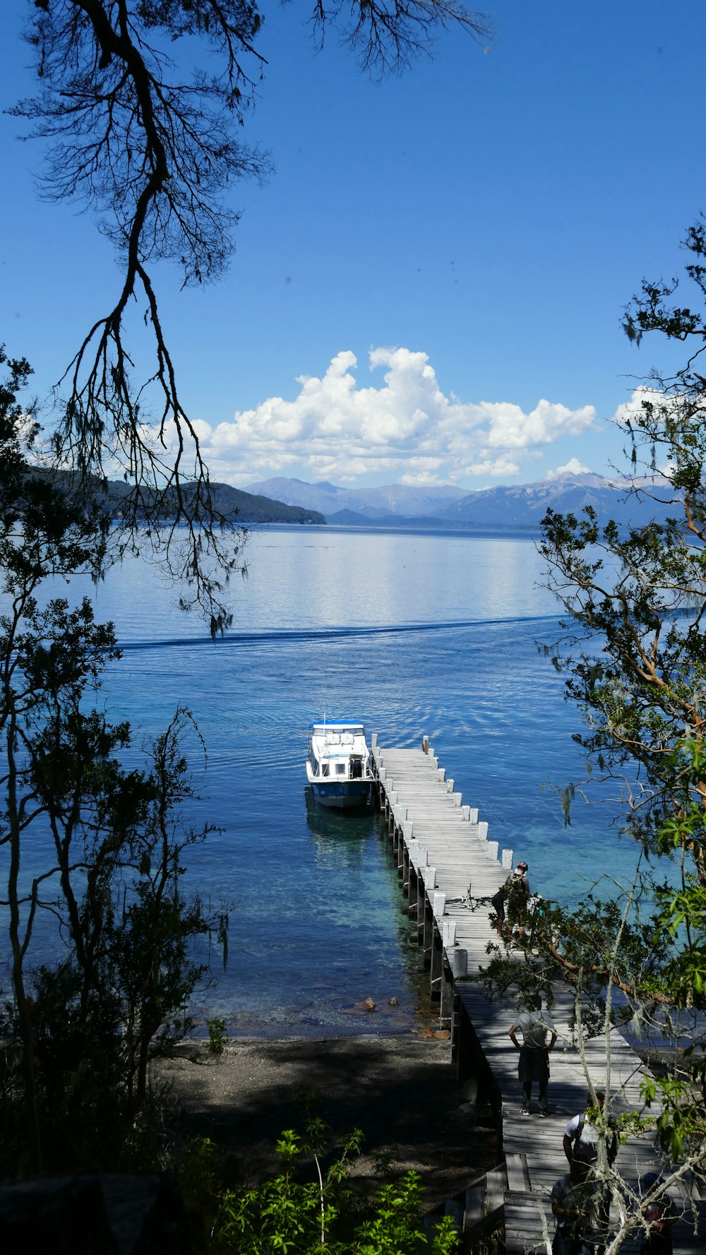 a boat is docked at the end of a pier