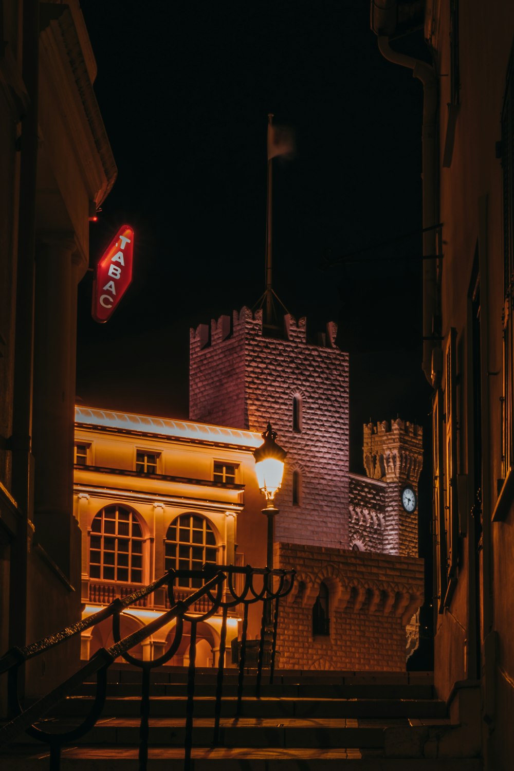 a building lit up at night with a coca cola sign