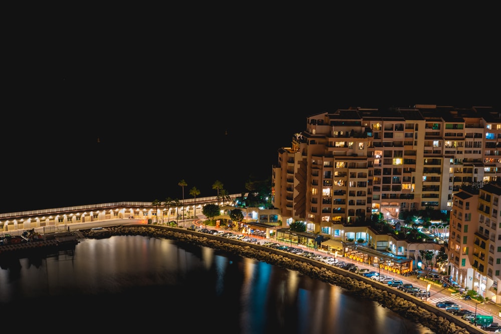 a night view of a city with a bridge over a body of water