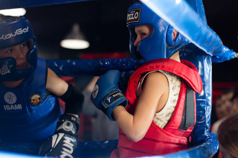 a woman in a blue boxing outfit and a man in a red vest