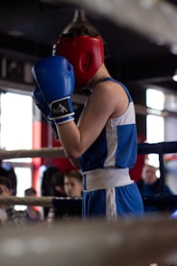 a young man wearing a red boxing glove
