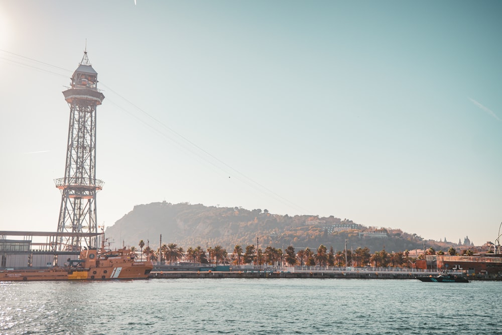 a large body of water with a tower in the background
