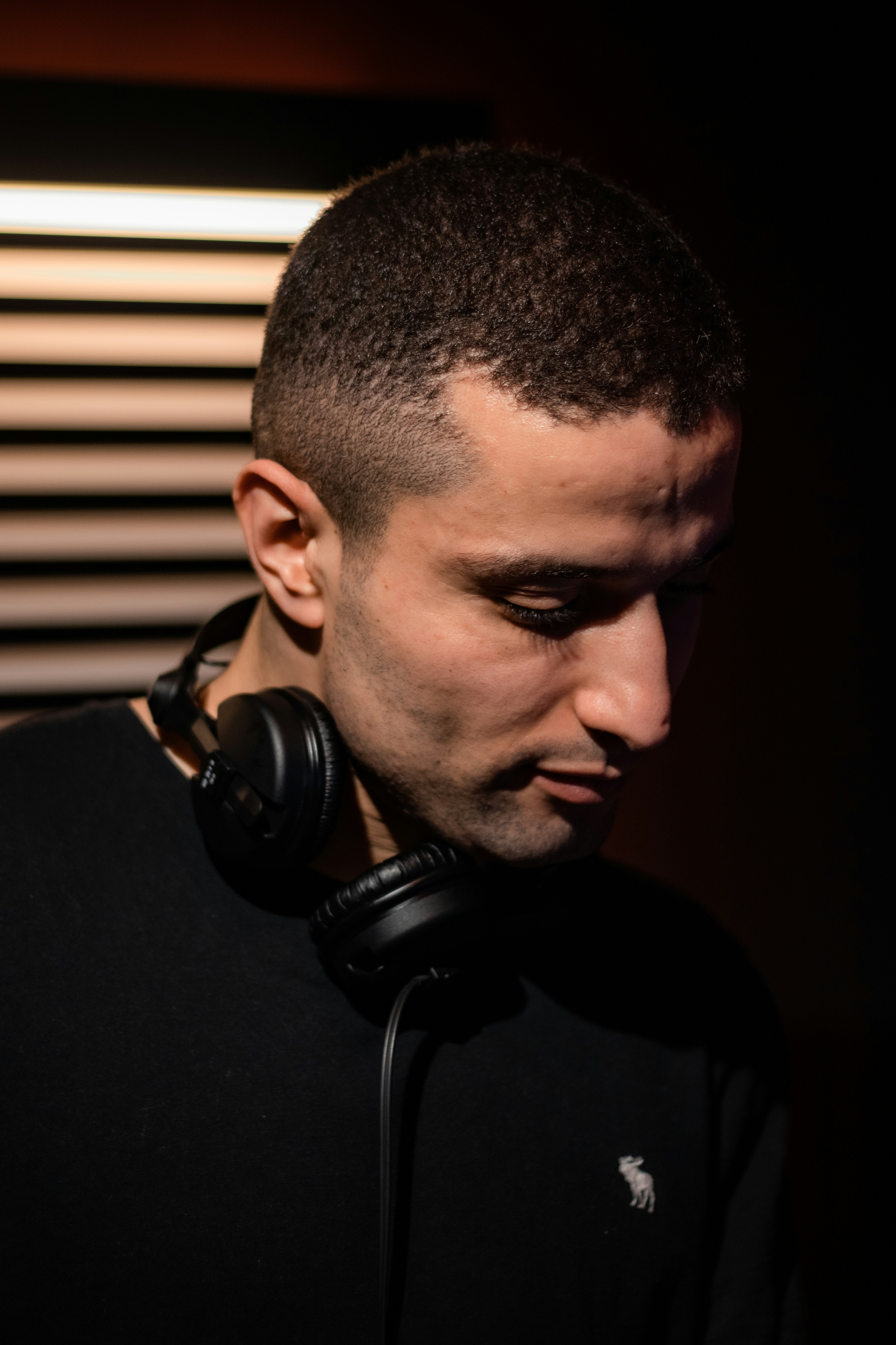a man wearing headphones in a dark room