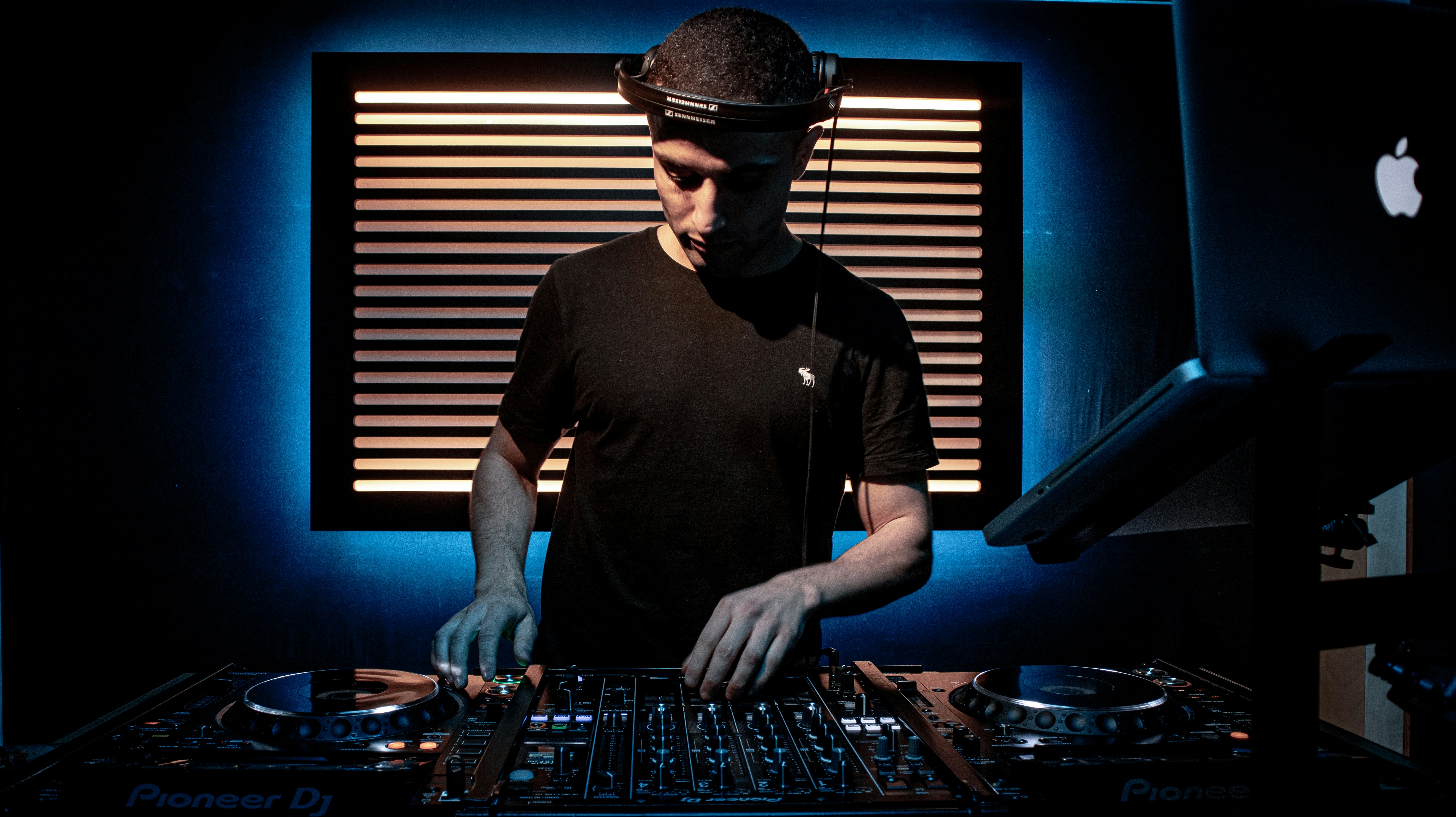 a man in a black shirt and headphones mixing music