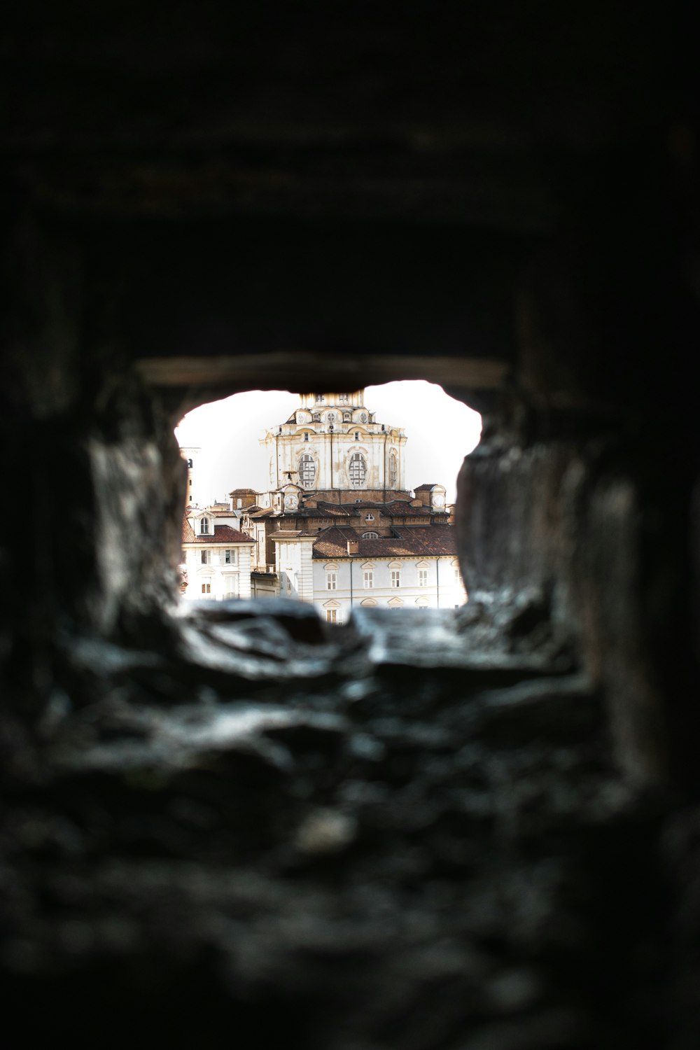 a view of a building through a hole in the ground