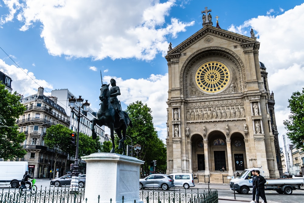 a statue of a man on a horse in front of a church