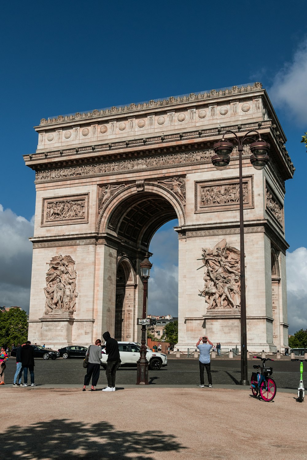 a group of people standing in front of a stone arch