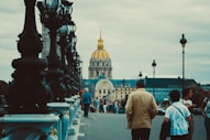 a group of people walking across a bridge