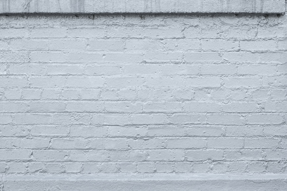 a black and white photo of a brick wall