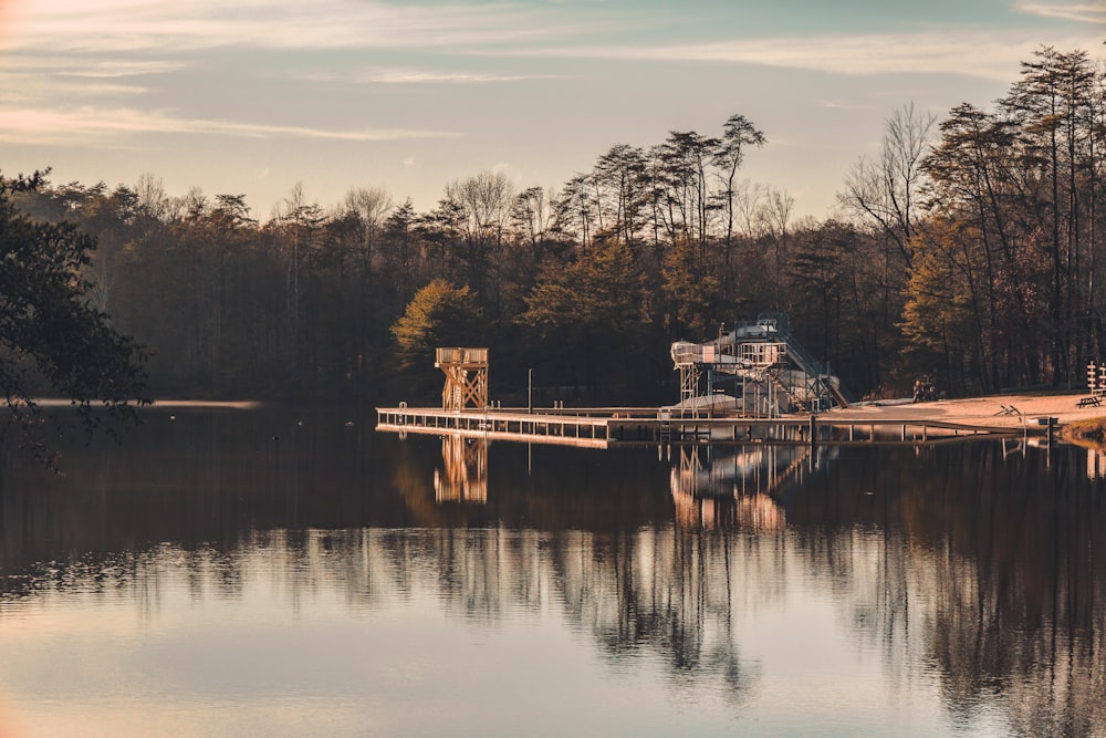 a boat dock on a lake surrounded by trees