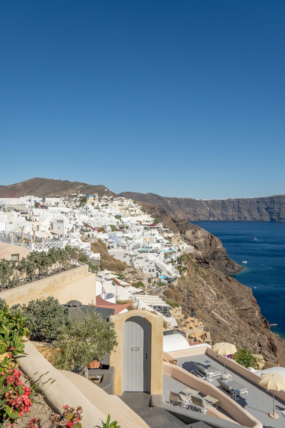 a scenic view of a town and the ocean