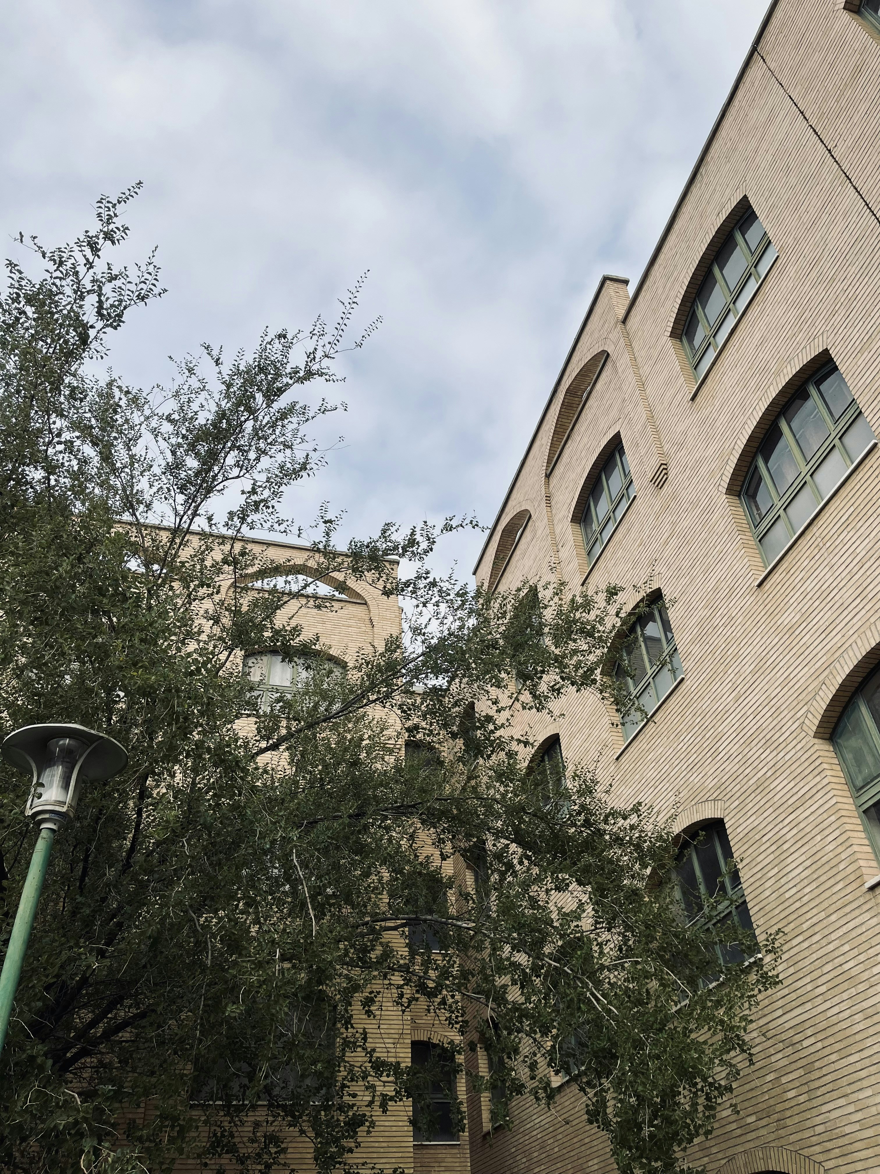 a street light sitting next to a tall brick building