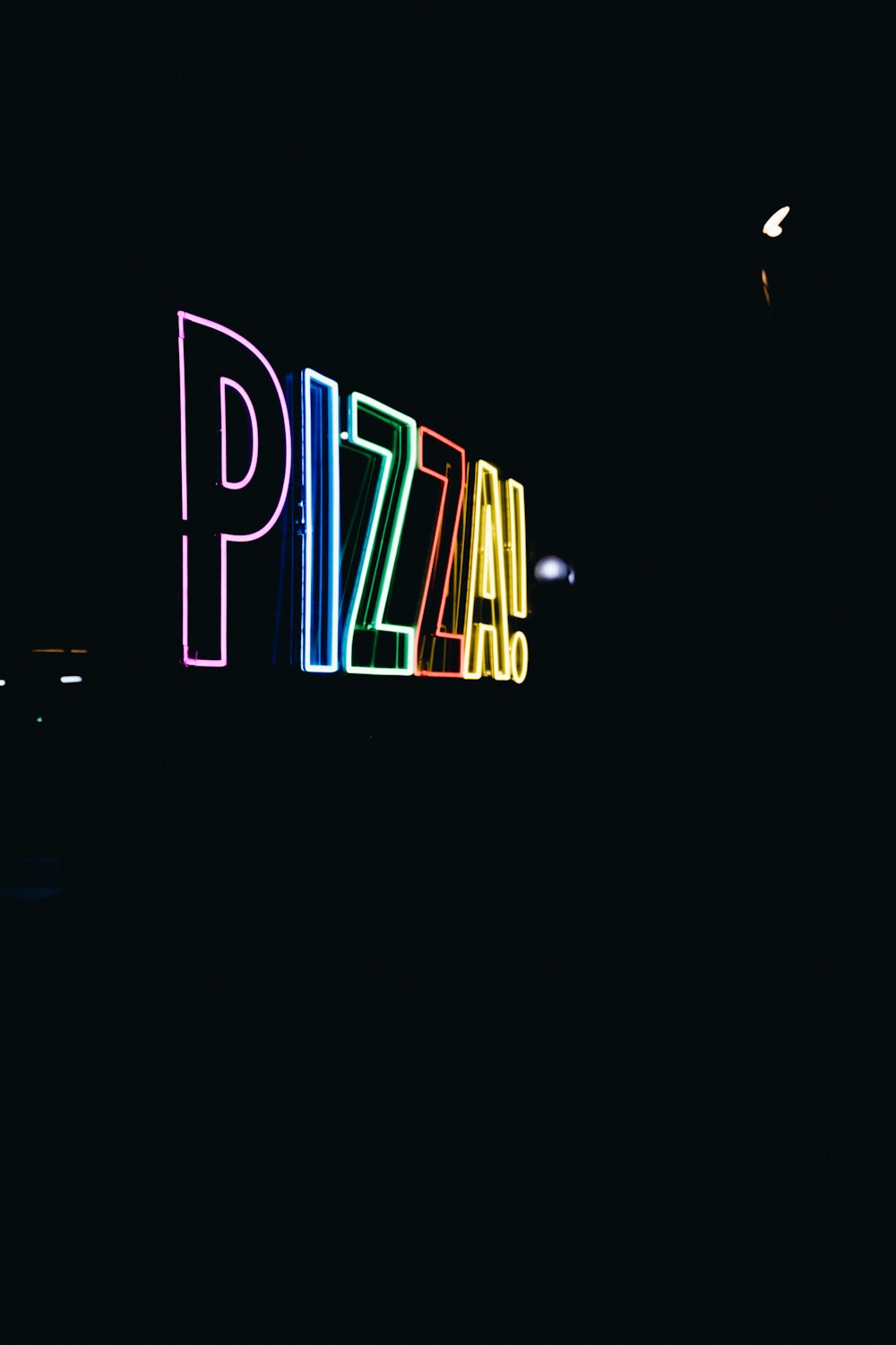 a neon sign that reads pizza on a dark background