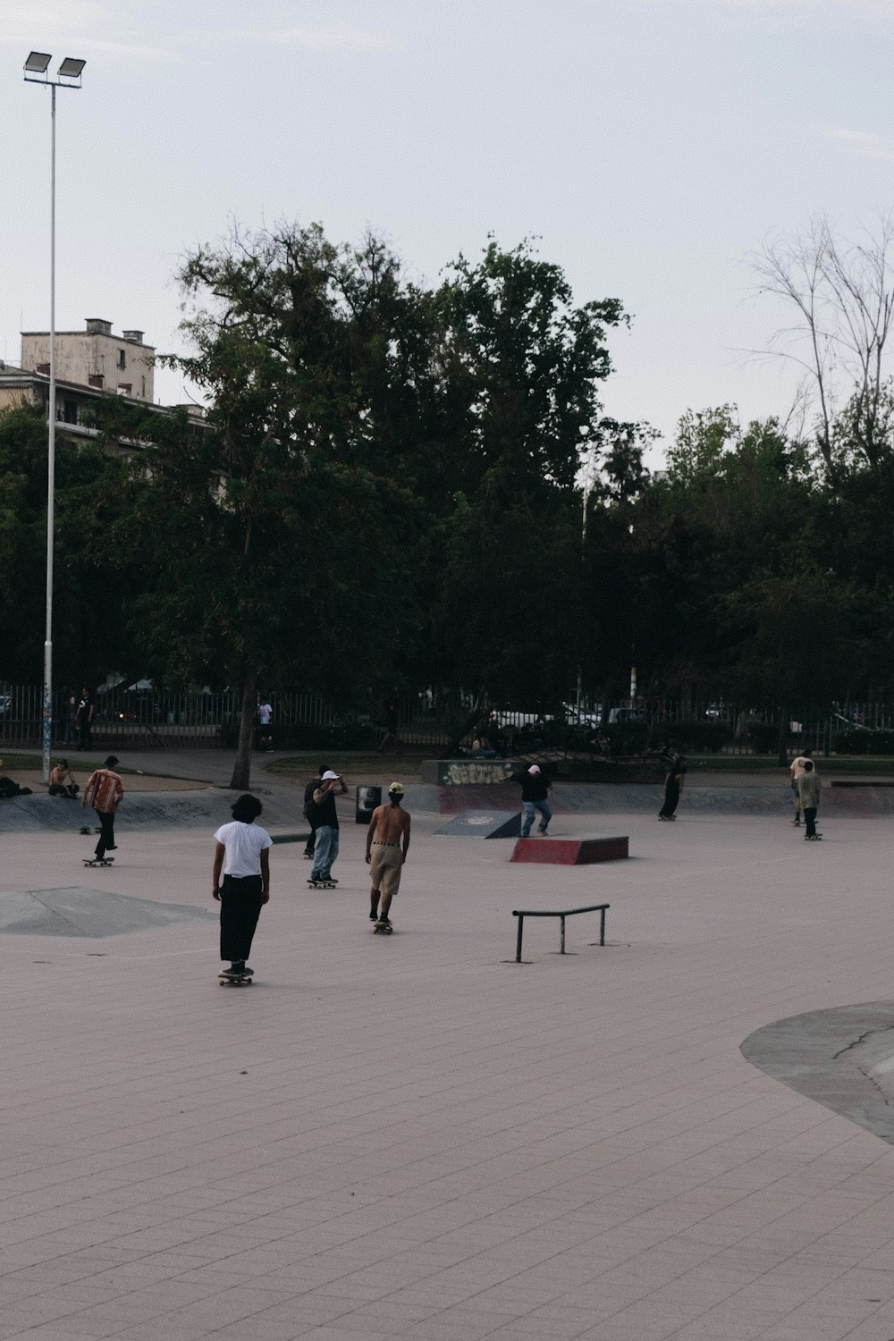 a group of people walking around a skate park