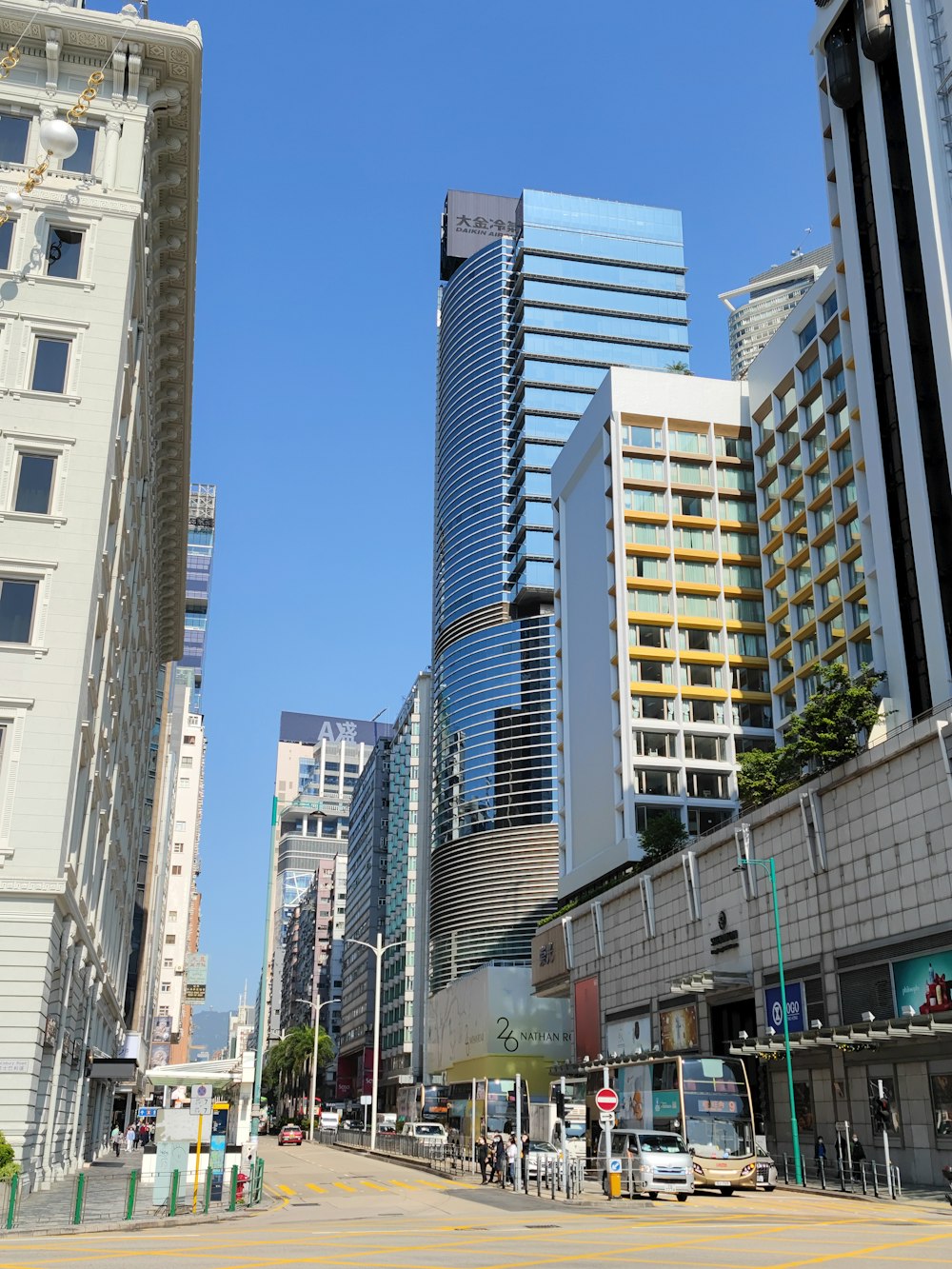 a city street with tall buildings in the background