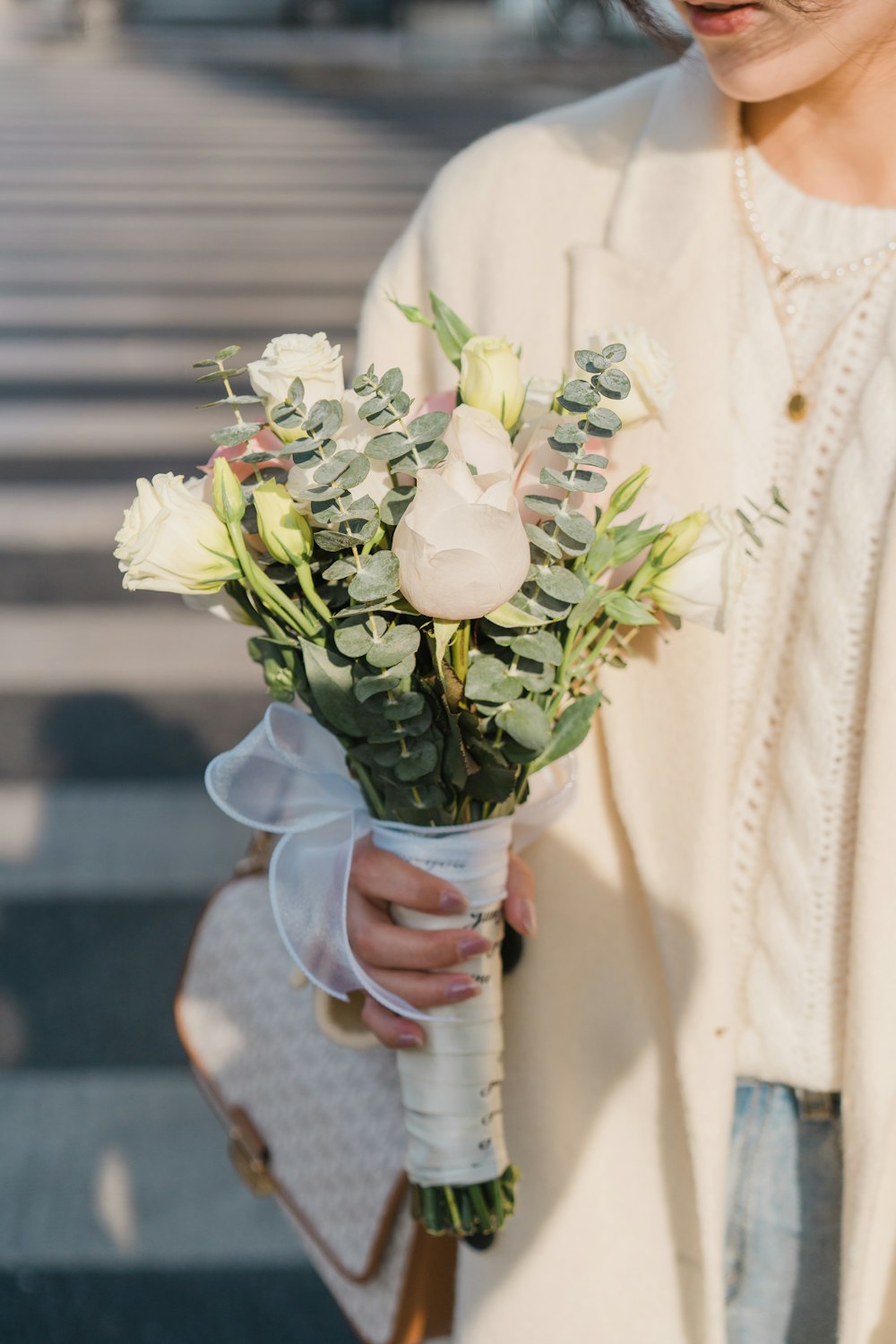 a woman is holding a bouquet of flowers