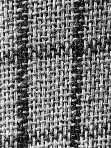 a black and white photo of a checkered fabric
