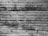 Close-up of a textured wooden surface with parallel lines and patches of dark, grainy dirt or mold.