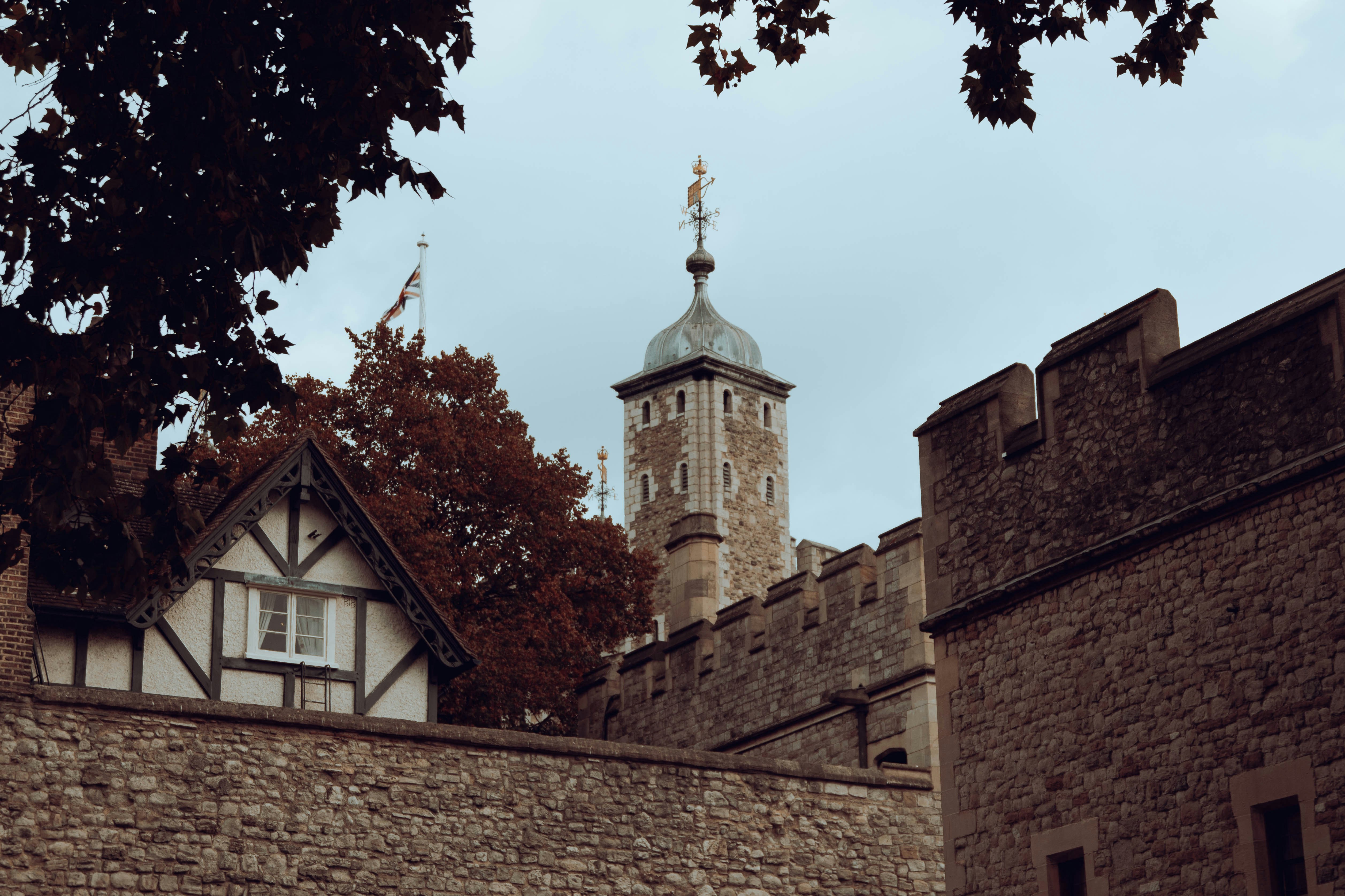 a tall brick building with a clock tower in the background