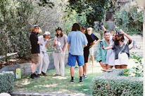 Guests enjoying outdoor activities in the green garden area of the hostel.
