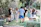 Guests mingling happily on the outdoor patio surrounded by lush greenery at One Ten Venue.