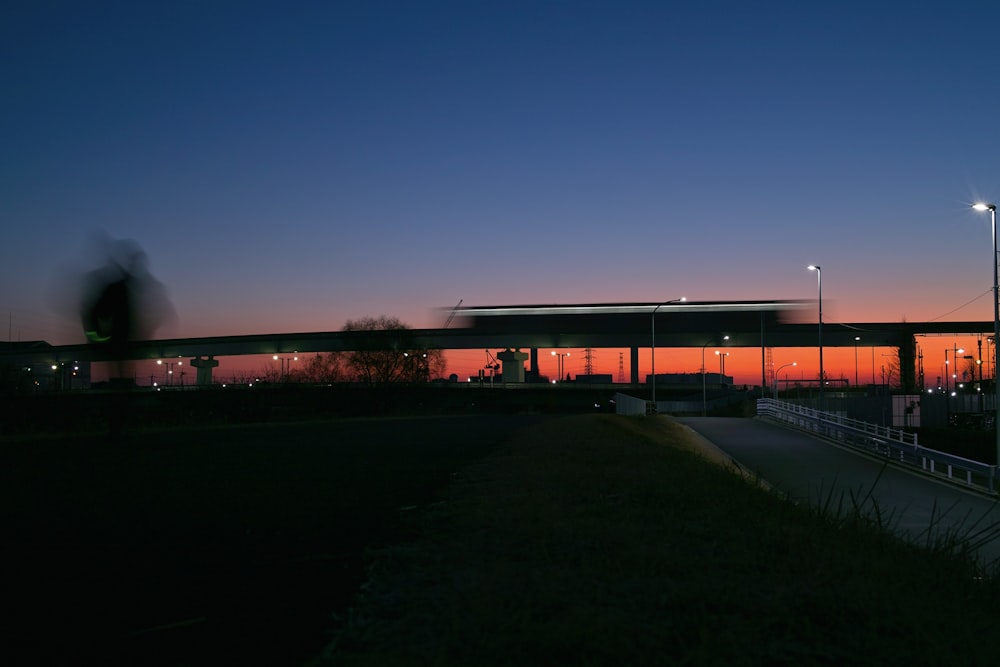 a view of a building at night from across the street