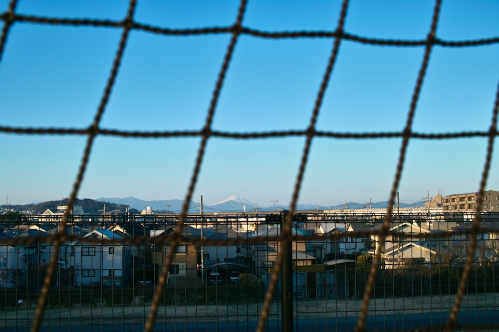 a view of a city from behind a fence