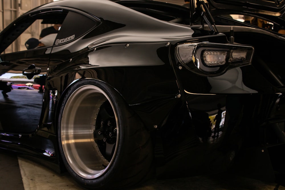 a close up of the front of a black sports car