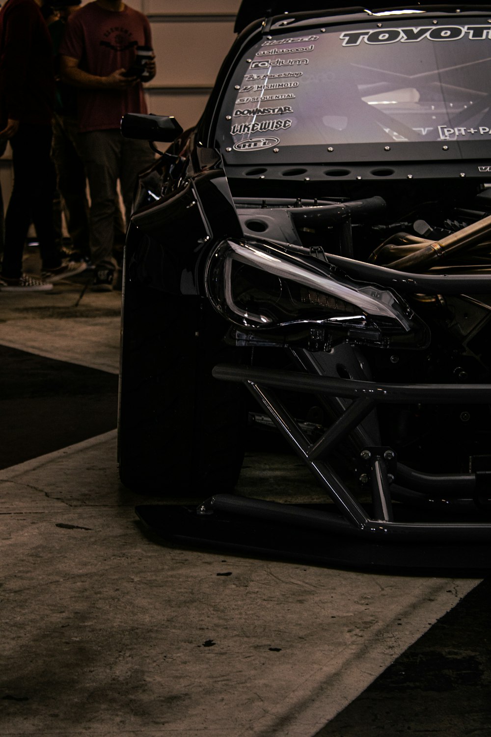 a car with its hood open on a street