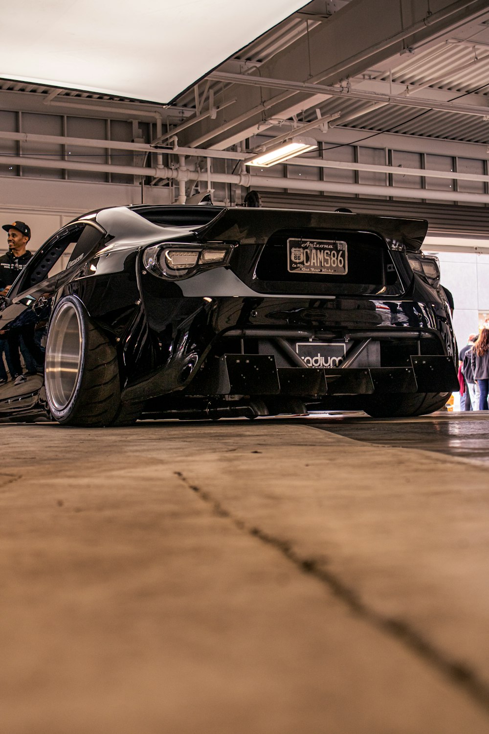 a black sports car parked in a garage