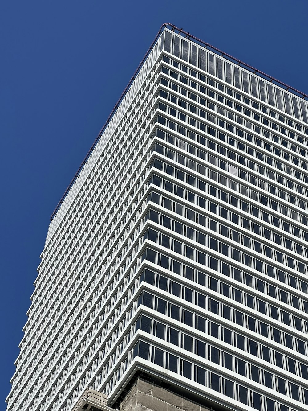 a tall building with lots of windows against a blue sky