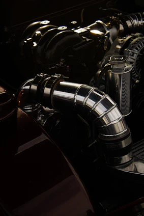 Close-up of a shiny metal vacuum pump part in a well-lit industrial setting