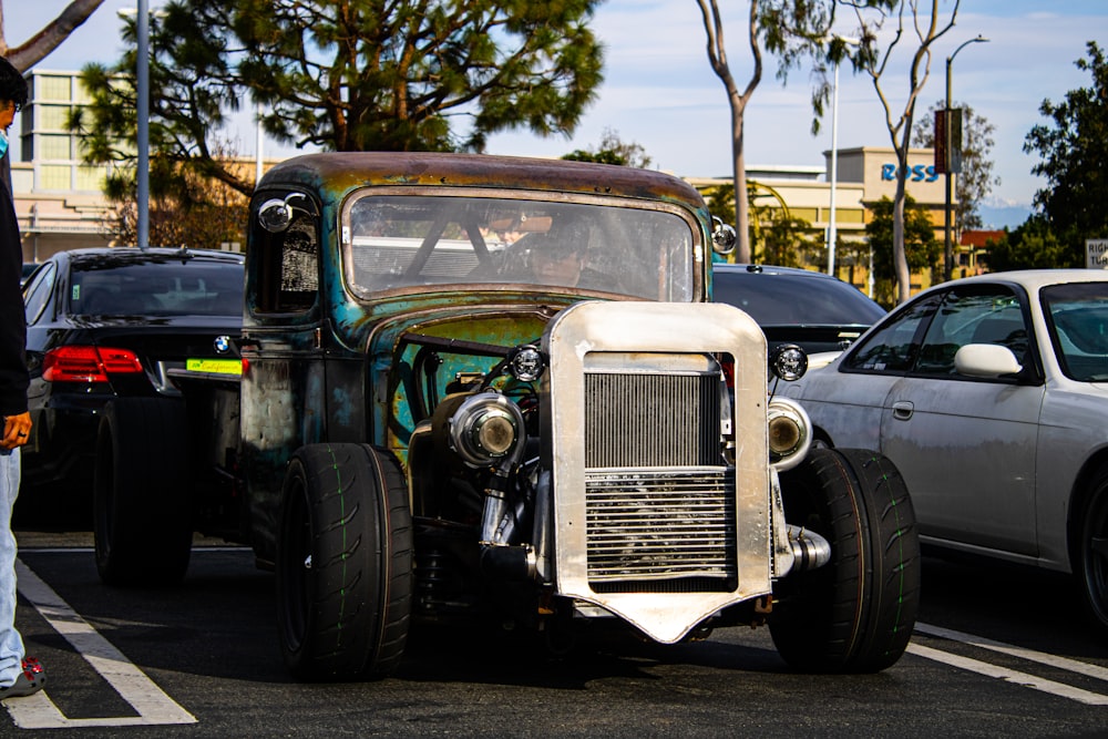 an old car is parked in a parking lot