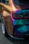 a colorful car parked on the side of the road