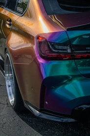 a colorful car parked on the side of the road