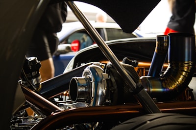 A close-up of a mechanic inspecting a car part in a workshop.