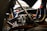 Close-up of automotive engine components arranged on a workbench.