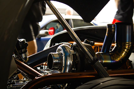 Close-up of a mechanic inspecting a car engine with diagnostic tools.