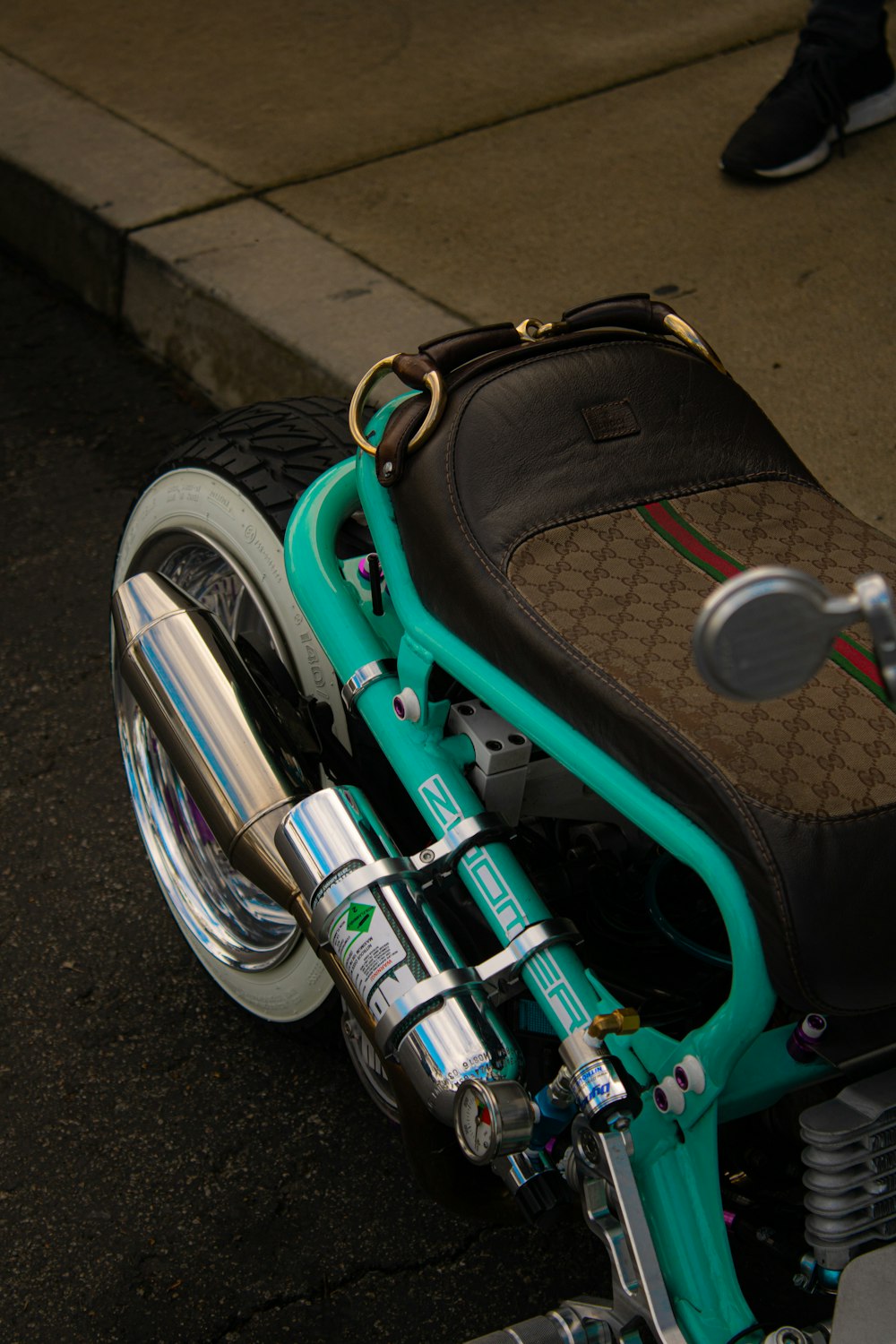 a close up of a motorcycle parked on the side of the road