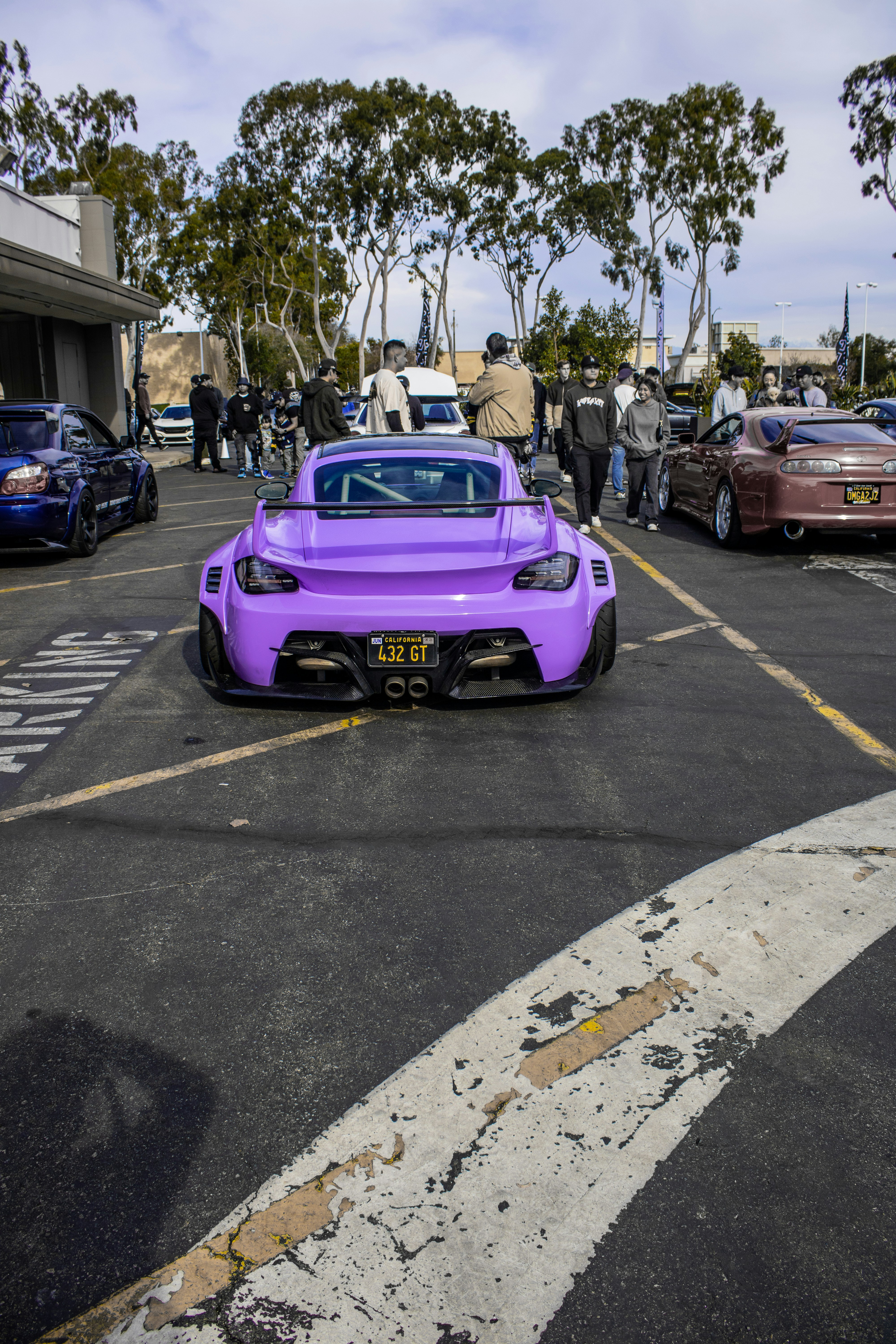 A purple sports car parked in a parking lot photo – Free Sports car ...