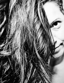 Artful black and white photo showing a guest’s hair flowing softly, embodying simplicity and style.