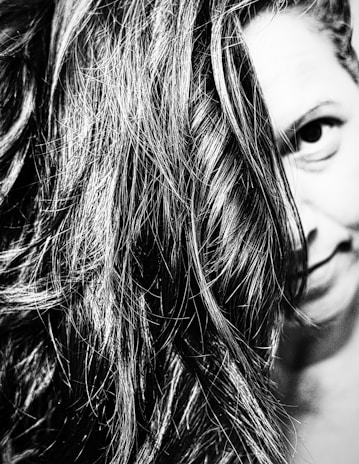 Artful black and white photo showing a guest’s hair flowing softly, embodying simplicity and style.