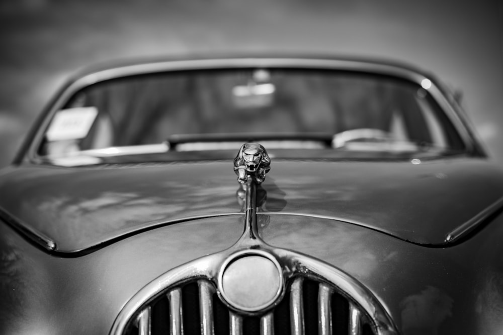 a black and white photo of a vintage car