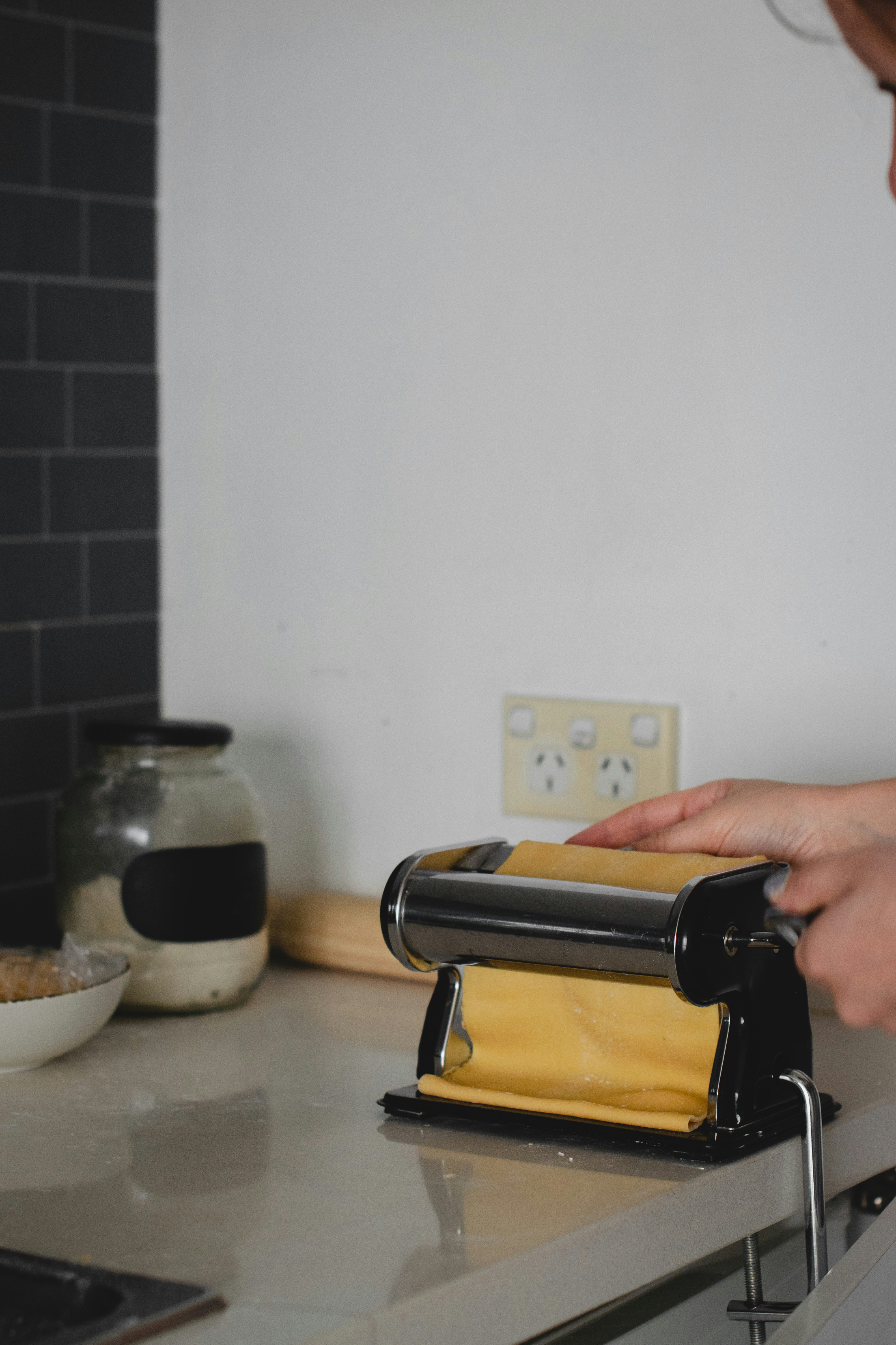 a woman is using a pastry cutter on a counter