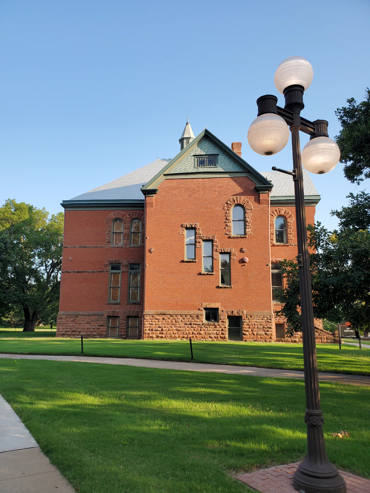 A red brick building with a stone base on the Oklahoma State University campus in Stillwater