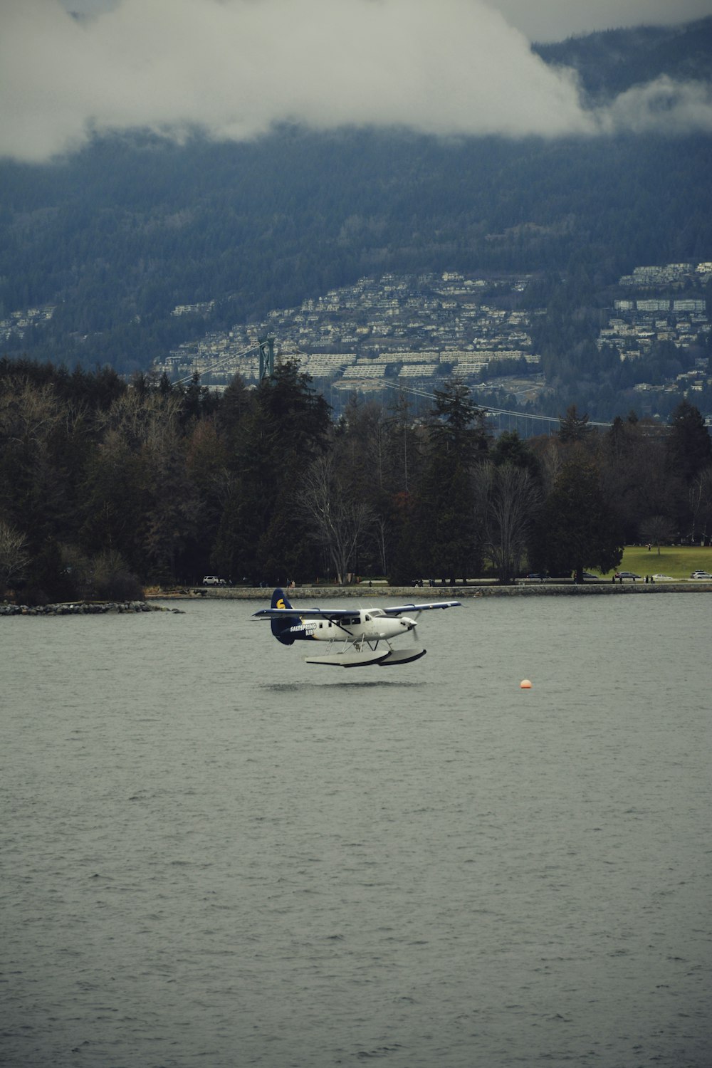 a small plane flying over a large body of water