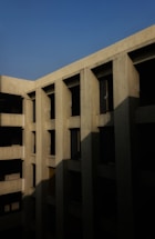 Photo of a sturdy concrete building facade under clear sky.